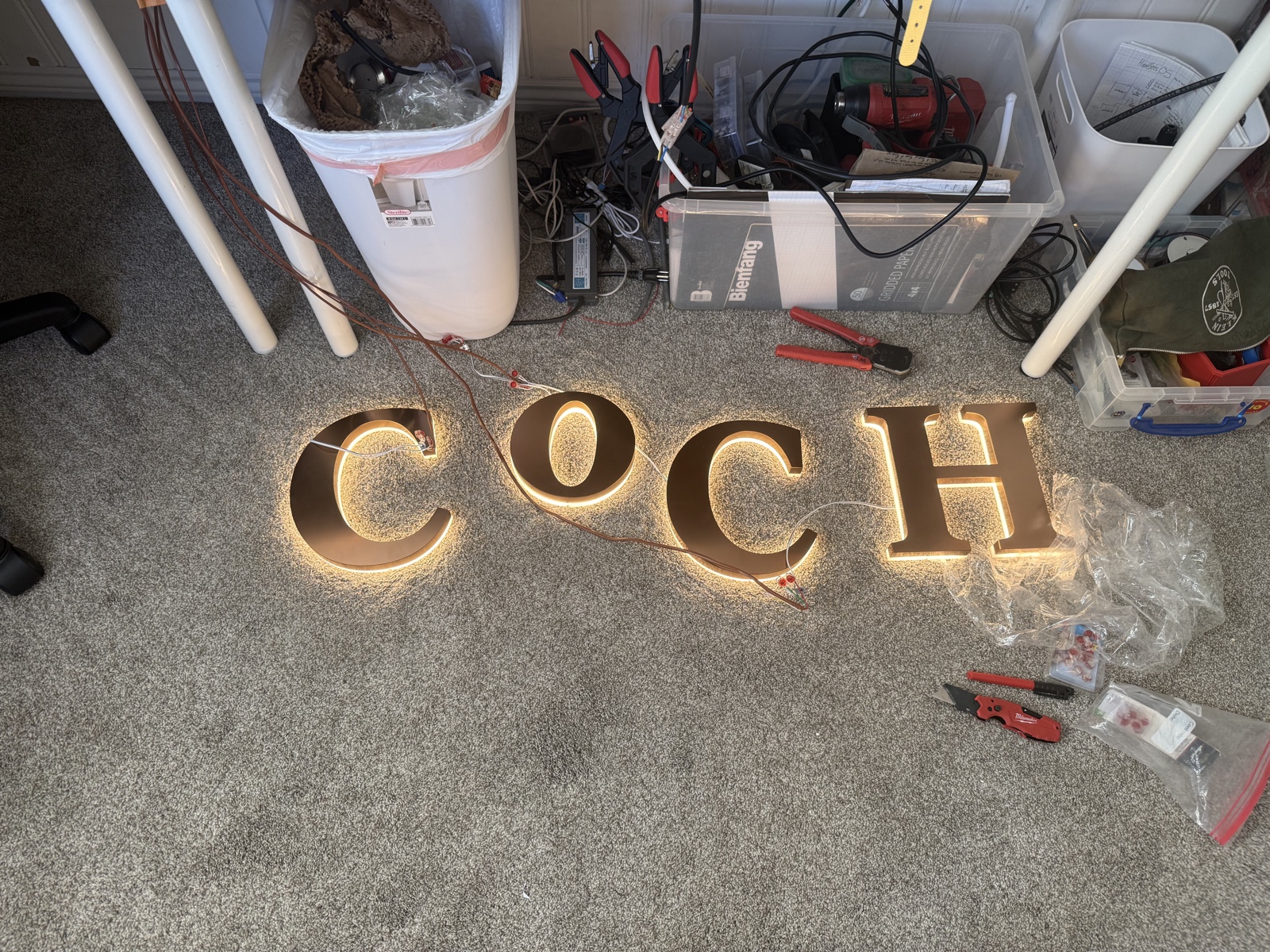 C O C H letters lit with warm white halo backlight